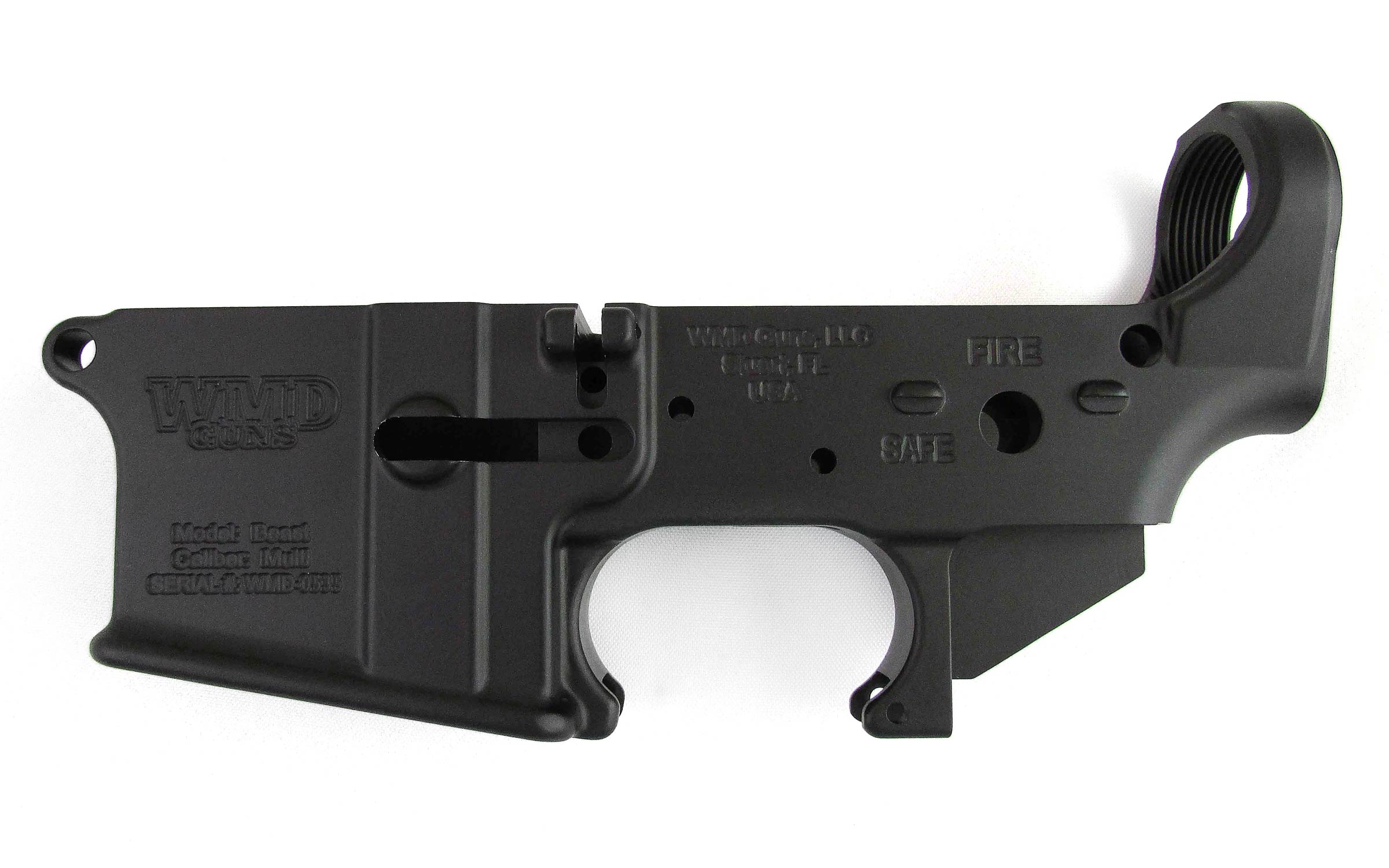 Black metal AR-15 lower receiver with engraved manufacturer markings and selector switch positions labeled SAFE and FIRE. The part is shown against a white background.