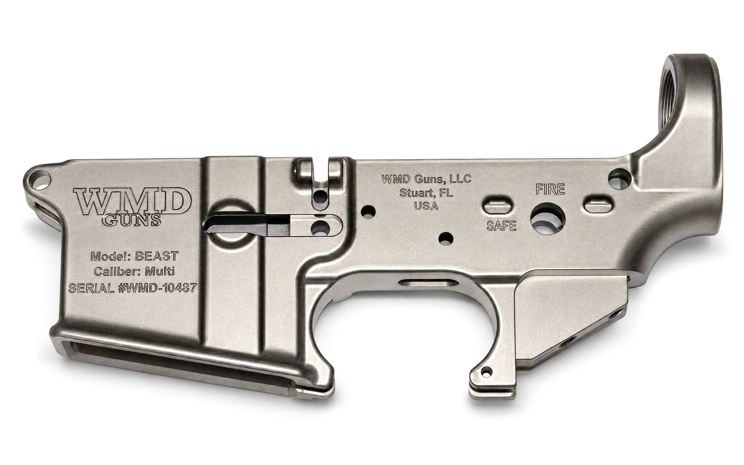 Metal firearm lower receiver labeled WMD Guns, with engraved serial number and controls for safe and fire. Manufacturer details and model information are visible.