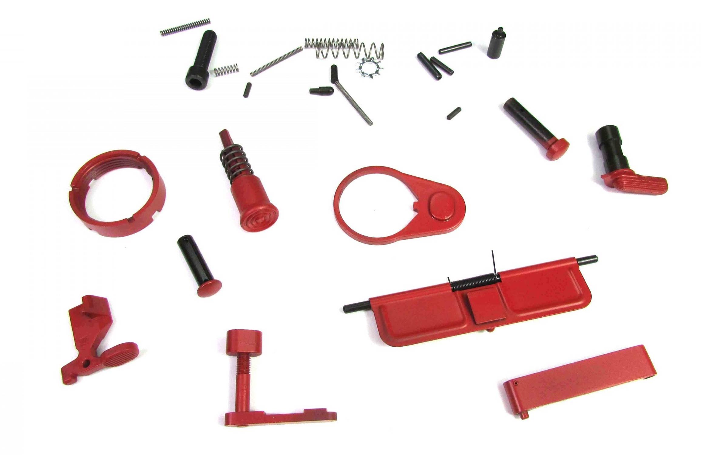 A collection of small red firearm parts, including levers, pins, springs, and a dust cover, arranged on a white background.