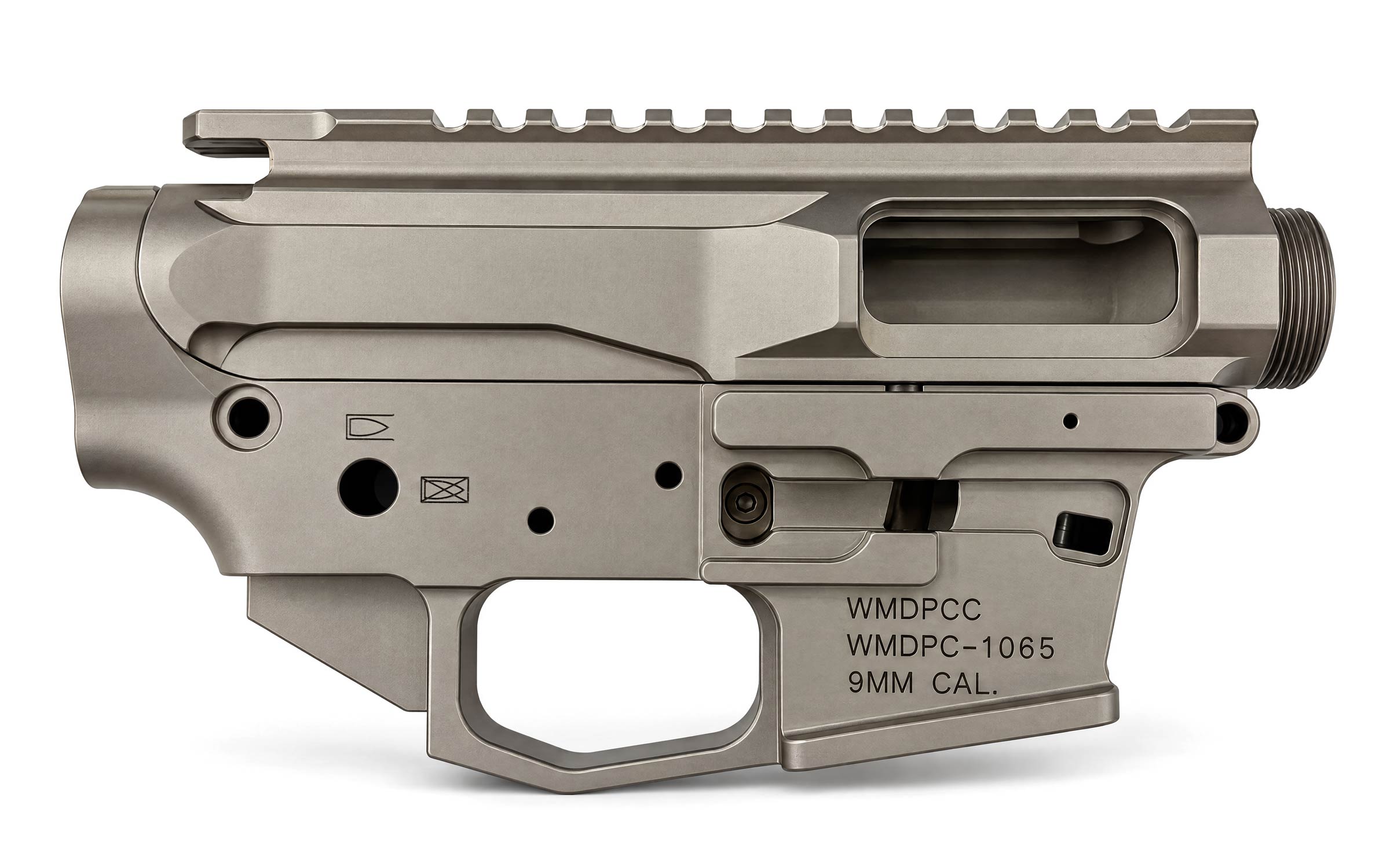 A gray metallic firearm receiver labeled WMDPCC, WMDPC-1065, and 9MM CAL.